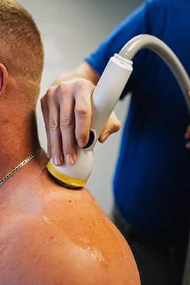 Softwave therapy being used on a patient's shoulder