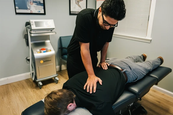 Chiropractor Barrington NH David Rivera Back Adjustment HP Dr. David Rivera adjusting a patient's back while the patient lays face down